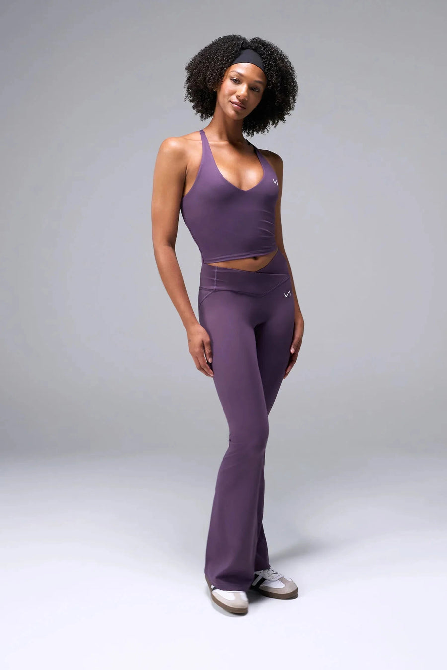 Back View of Purple TLF Tempo Flare Leggings, featuring a waist snatching crossover waistband and glute shaping side seam 