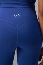 Back View of Blue TLF Tempo Flare Leggings, featuring a waist snatching crossover waistband and glute shaping side seam 