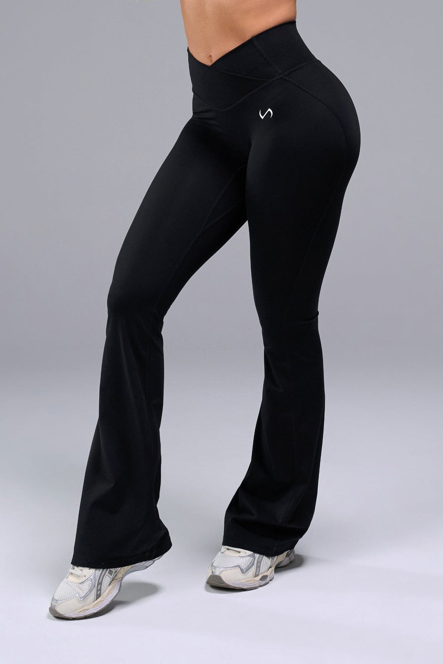Front View of Black TLF Tempo Flare Leggings, featuring a waist snatching crossover waistband and glute shaping side seam 