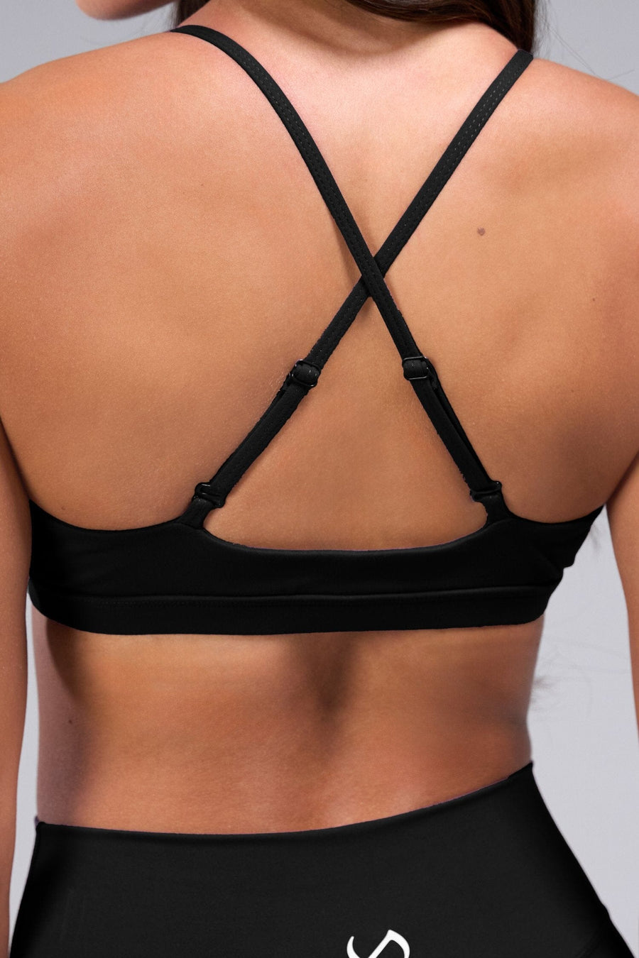 Zoomed Back View of Black TLF Tempo Front Clasp Sports Bra 2.0 with a strappy back and front closure, designed for style and support 