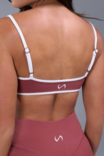 Back View of Orange Tempo Minimal Bralette 2.0, featuring removable pads and adjustable straps for low impact all day wear
