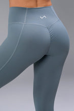 Back View of Blue TLF Tempo Scrunch Butt Leggings, featuring a butt scrunch that shapes your glutes with a snatched waist seam design 