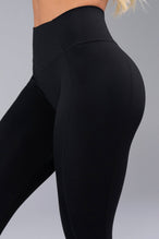 Side View of Black TLF Tempo Scrunch Butt Leggings, featuring a butt scrunch that shapes your glutes with a snatched waist seam design 