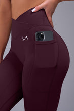 Side View of Wine TLF Tempo Side Pocket Leggings, featuring dual side pockets and crossover waistband for performance and functionality 