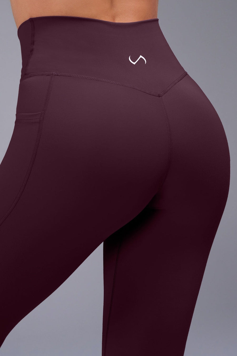 Side View of Wine TLF Tempo Side Pocket Leggings, featuring dual side pockets and crossover waistband for performance and functionality 