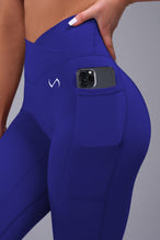 Side View of Blue TLF Tempo Side Pocket Leggings, featuring dual side pockets and crossover waistband for performance and functionality 