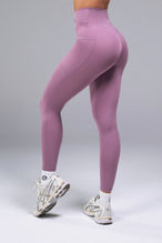 Side View of Purple TLF Tempo Side Pocket Leggings, featuring dual side pockets and crossover waistband for performance and functionality 