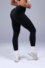 Back View of Black TLF Tempo Side Pocket Leggings, featuring dual side pockets and crossover waistband for performance and functionality 