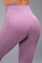 Back View of Purple TLF Tempo Side Pocket Leggings, featuring dual side pockets and crossover waistband for performance and functionality 