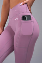 Detail Side View of Purple TLF Tempo Side Pocket Leggings, featuring dual side pockets and crossover waistband for performance and functionality 