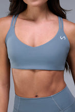 Detail Front View of Blue TLF Tempo Strappy Back Sports Bra, featuring a minimal design for the gym and lifestyle wear 