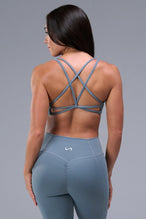Back View of Blue TLF Tempo Strappy Back Sports Bra, featuring a minimal design for the gym and lifestyle wear 