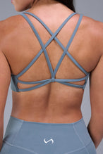 Back View of Blue TLF Tempo Strappy Back Sports Bra, featuring a minimal design for the gym and lifestyle wear 