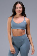 Front View of Blue TLF Tempo Strappy Back Sports Bra, featuring a minimal design for the gym and lifestyle wear 