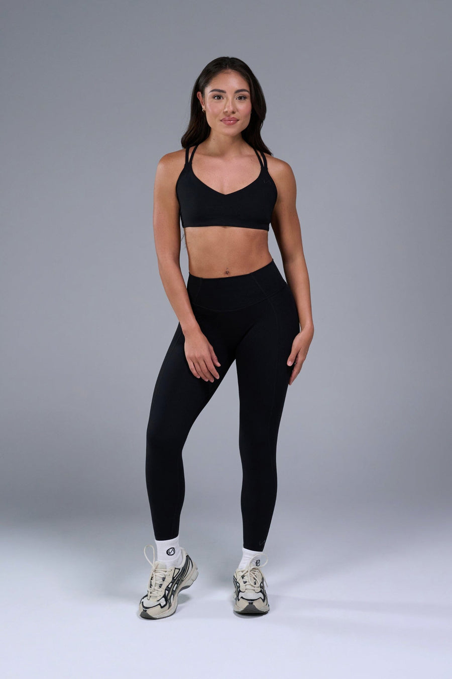 Front View of Black TLF Tempo Strappy Back Sports Bra, featuring a minimal design for the gym and lifestyle wear 
