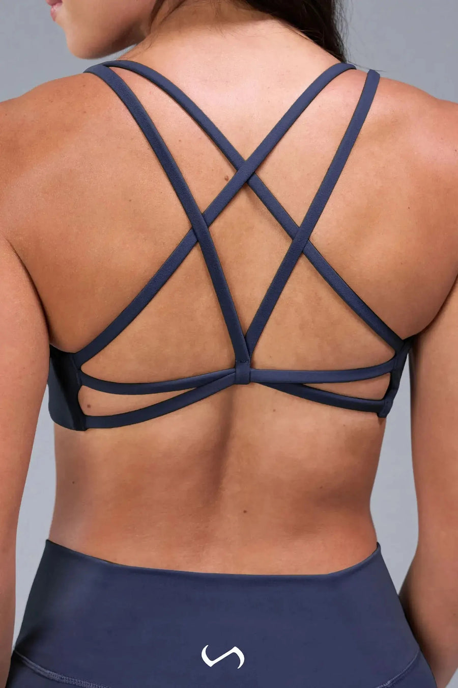 Back View of Blue TLF Tempo Strappy Back Sports Bra, featuring a minimal design for the gym and lifestyle wear 