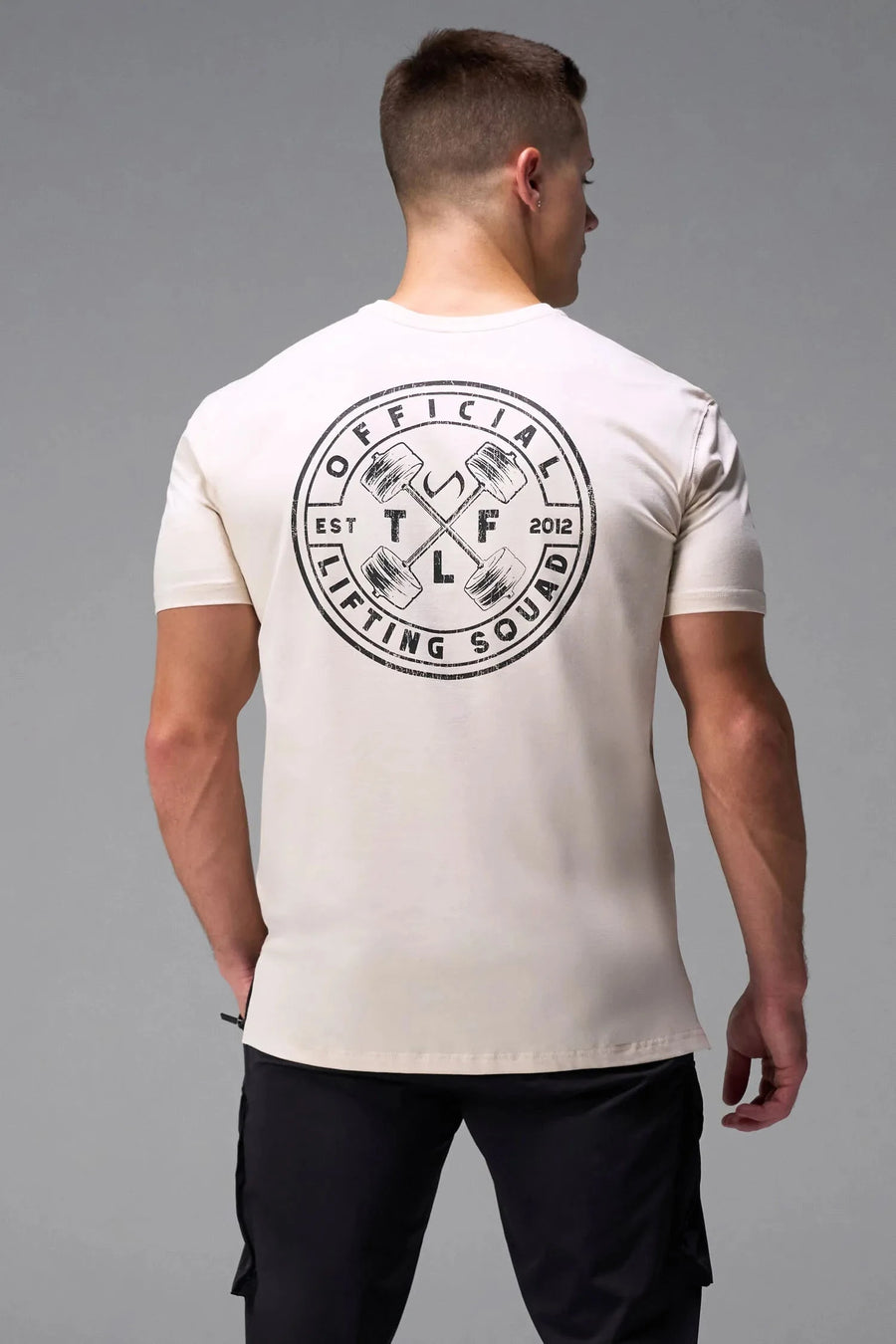 Back View of Oatmilk TLF Cross weights Swole Tee featuring our swole fit and custom graphic print design on center back