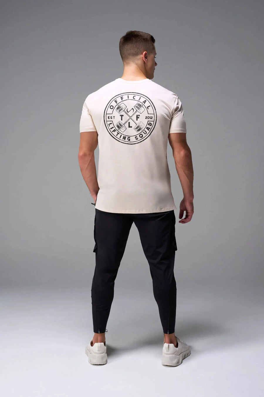 Back View of Oatmilk TLF Cross weights Swole Tee featuring our swole fit and custom graphic print design on center back