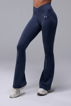 Front View of Blue TLF Tempo Flare Leggings, featuring a waist snatching crossover waistband and glute shaping side seam 