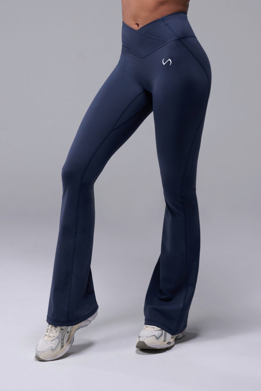 Front View of Blue TLF Tempo Flare Leggings, featuring a waist snatching crossover waistband and glute shaping side seam 
