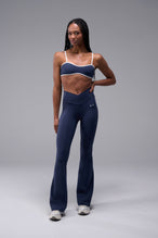 Front View of Blue TLF Tempo Flare Leggings, featuring a waist snatching crossover waistband and glute shaping side seam 