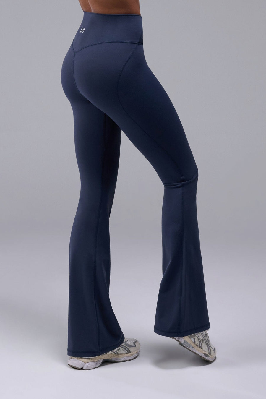 Side View of Blue TLF Tempo Flare Leggings, featuring a waist snatching crossover waistband and glute shaping side seam 
