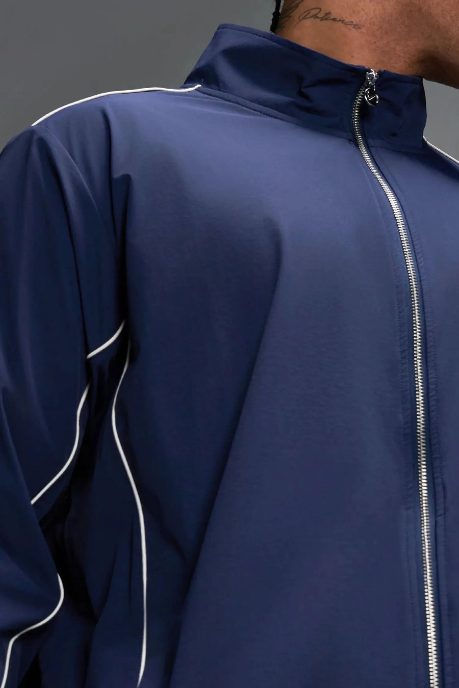 Detail View of Blue TLF Track Jacket (Men’s GTS Gym-To-Street Edition) with mesh lining, reflective piping, and premium trims for all-day Gym-To-Street wear. 