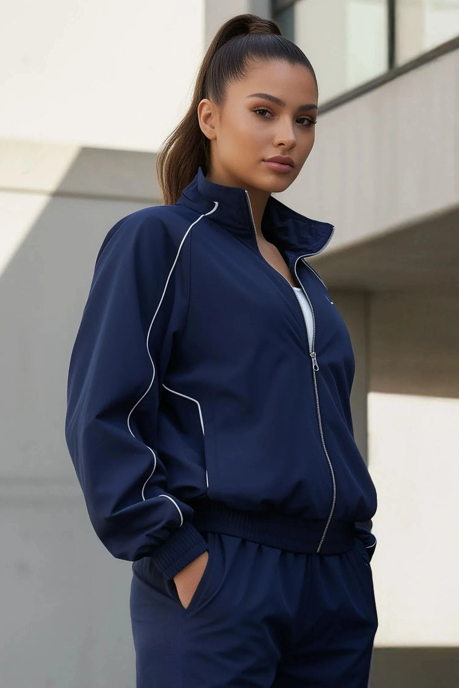 Front View of Blue TLF Track Jacket (Women’s GTS Gym-To-Street Edition) with mesh lining, reflective piping, and premium trims.