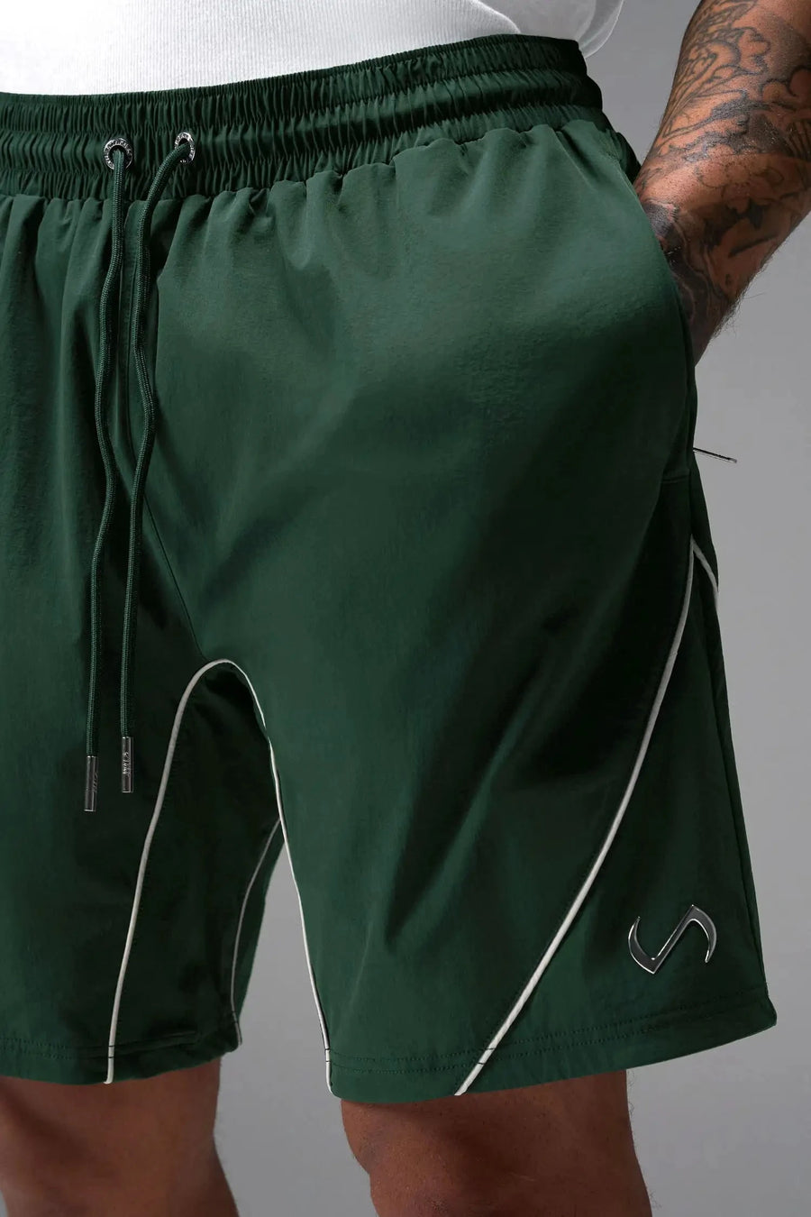 Front View of Green TLF Track Shorts (Men’s GTS Gym-To-Street Edition) featuring side zipper pockets, mesh lining and reflective piping details.