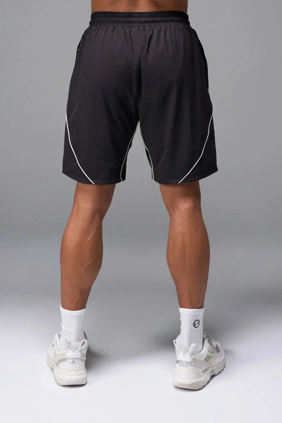 Back View of Black TLF Track Shorts (Men’s GTS Gym-To-Street Edition) featuring side zipper pockets, mesh lining and reflective piping details.