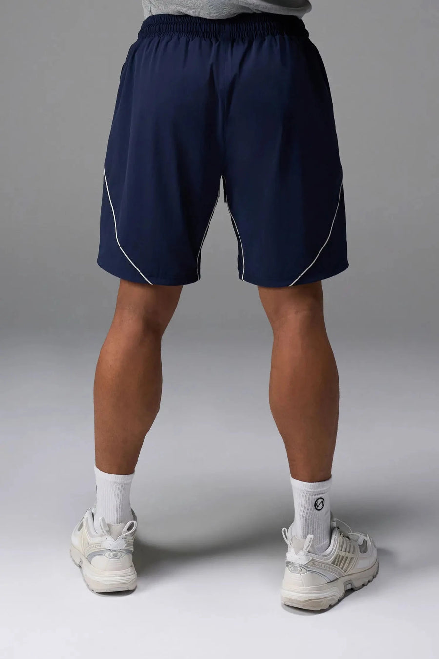 Back View of Blue TLF Track Shorts (Men’s GTS Gym-To-Street Edition) featuring side zipper pockets, mesh lining and reflective piping details.