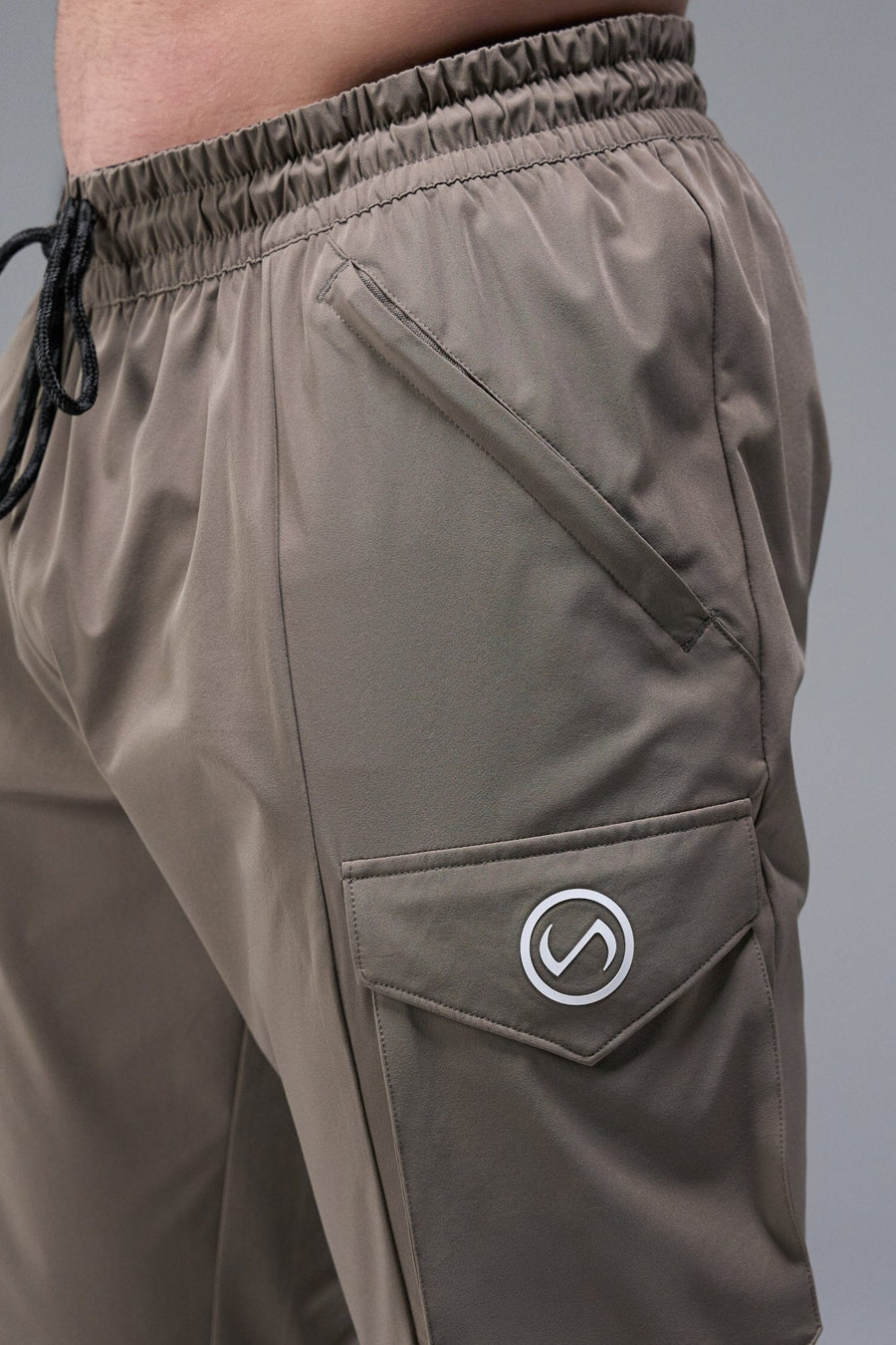 Detail Front View of Brown TLF Train Element 7/8 Joggers 2.0, featuring side cargo pockets in an athletic 7/8 length and side zipper pockets 