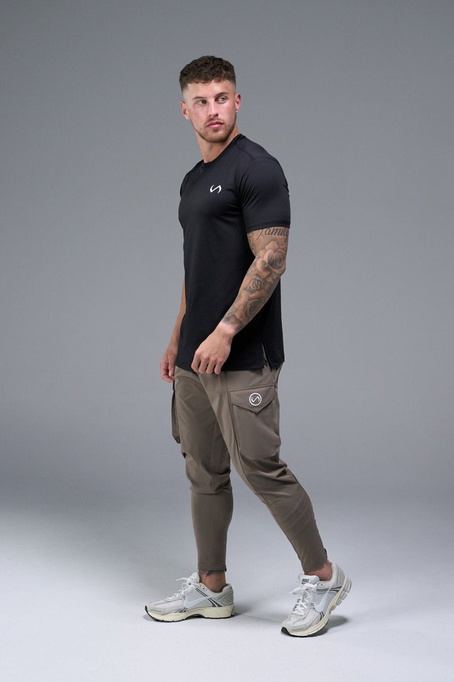 Side View of Brown TLF Train Element 7/8 Joggers 2.0, featuring side cargo pockets in an athletic 7/8 length and side zipper pockets 