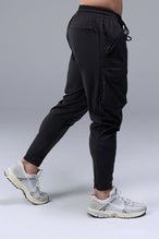 Side View of Black TLF Train Element 7/8 Joggers 2.0, featuring side cargo pockets in an athletic 7/8 length and side zipper pockets 