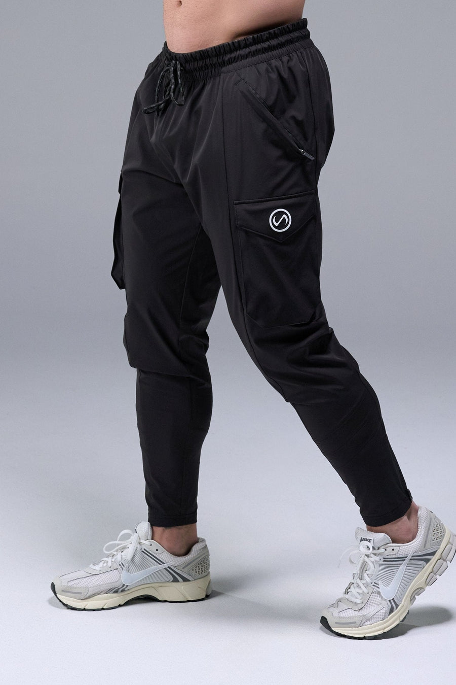 Front View of Black TLF Train Element 7/8 Joggers 2.0, featuring side cargo pockets in an athletic 7/8 length and side zipper pockets 