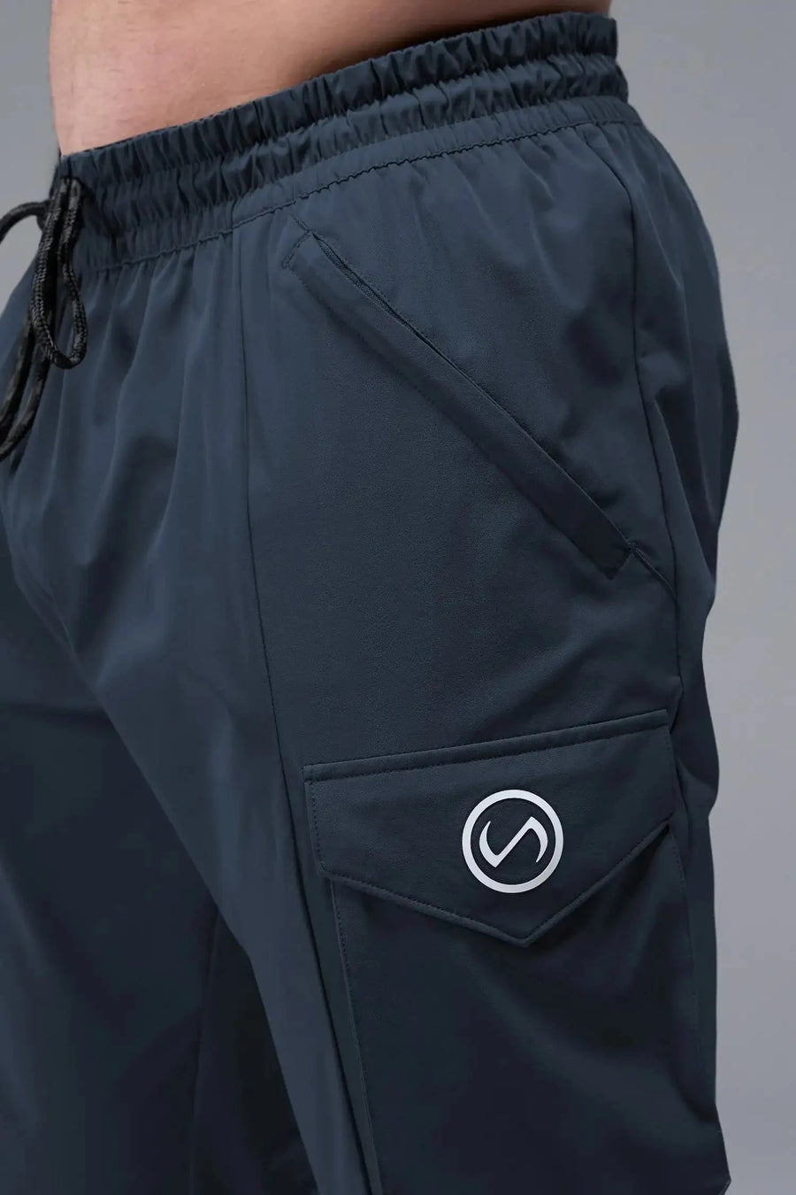 Detail Front View of Blue TLF Train Element 7/8 Joggers 2.0, featuring side cargo pockets in an athletic 7/8 length and side zipper pockets 