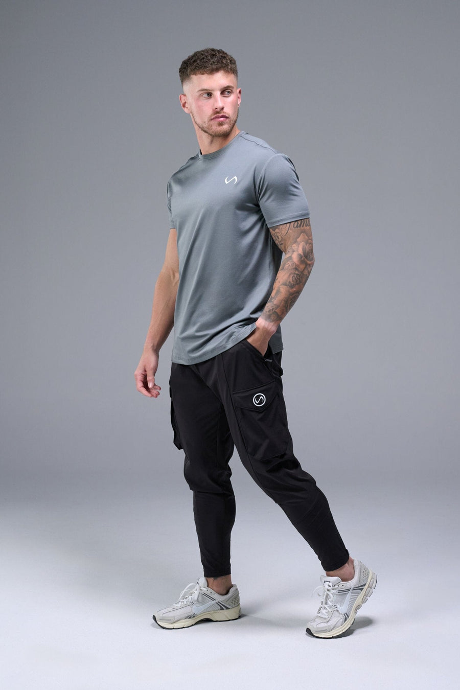 Side View of Black TLF Train Element 7/8 Joggers 2.0, featuring side cargo pockets in an athletic 7/8 length and side zipper pockets 