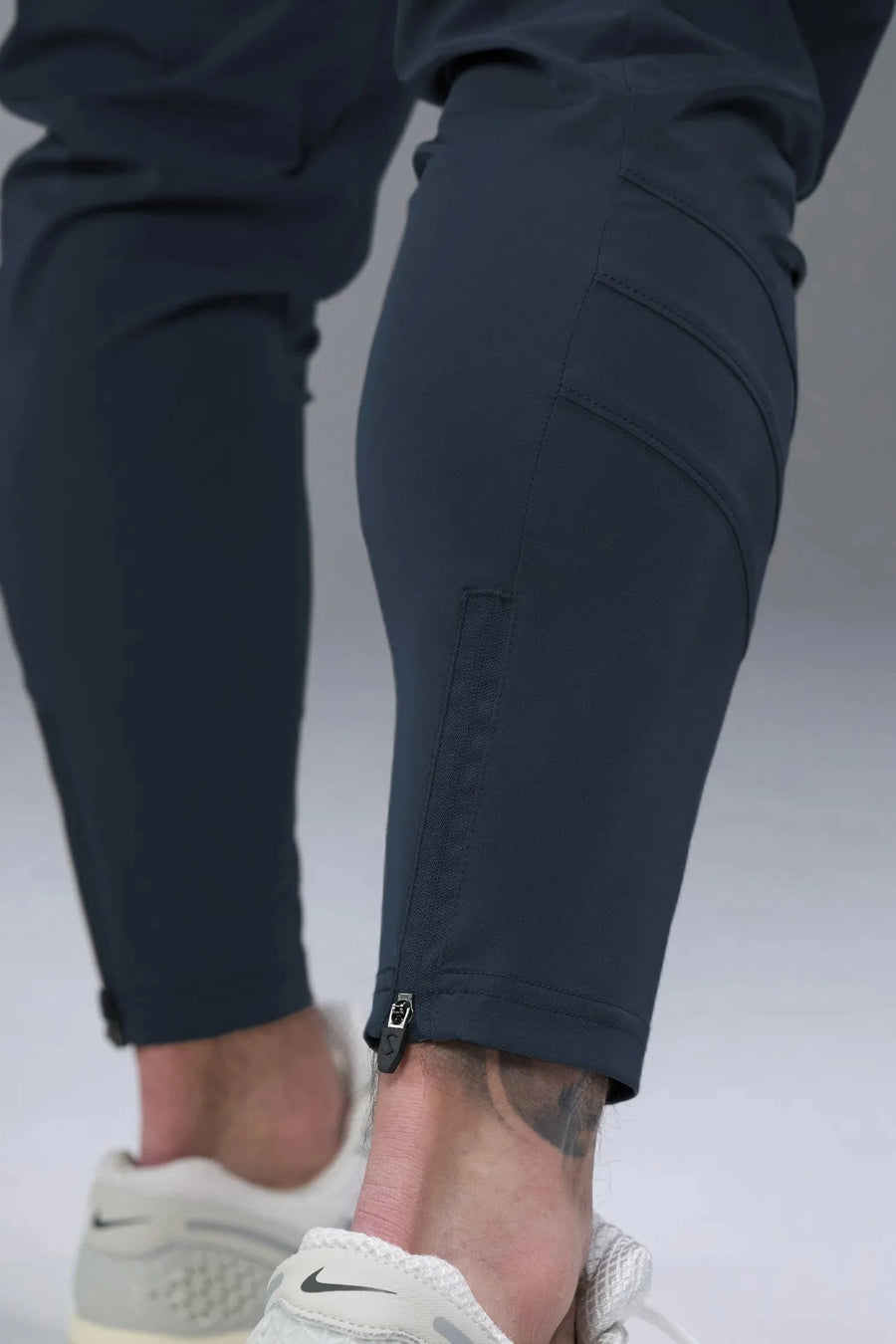 Side View of Blue TLF Train Element 7/8 Joggers 2.0, featuring side cargo pockets in an athletic 7/8 length and side zipper pockets 
