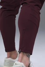 Side View of Maroon TLF Train Element 7/8 Joggers 2.0, featuring side cargo pockets in an athletic 7/8 length and side zipper pockets 