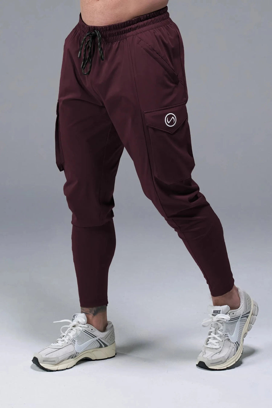 Front View of Maroon TLF Train Element 7/8 Joggers 2.0, featuring side cargo pockets in an athletic 7/8 length and side zipper pockets 
