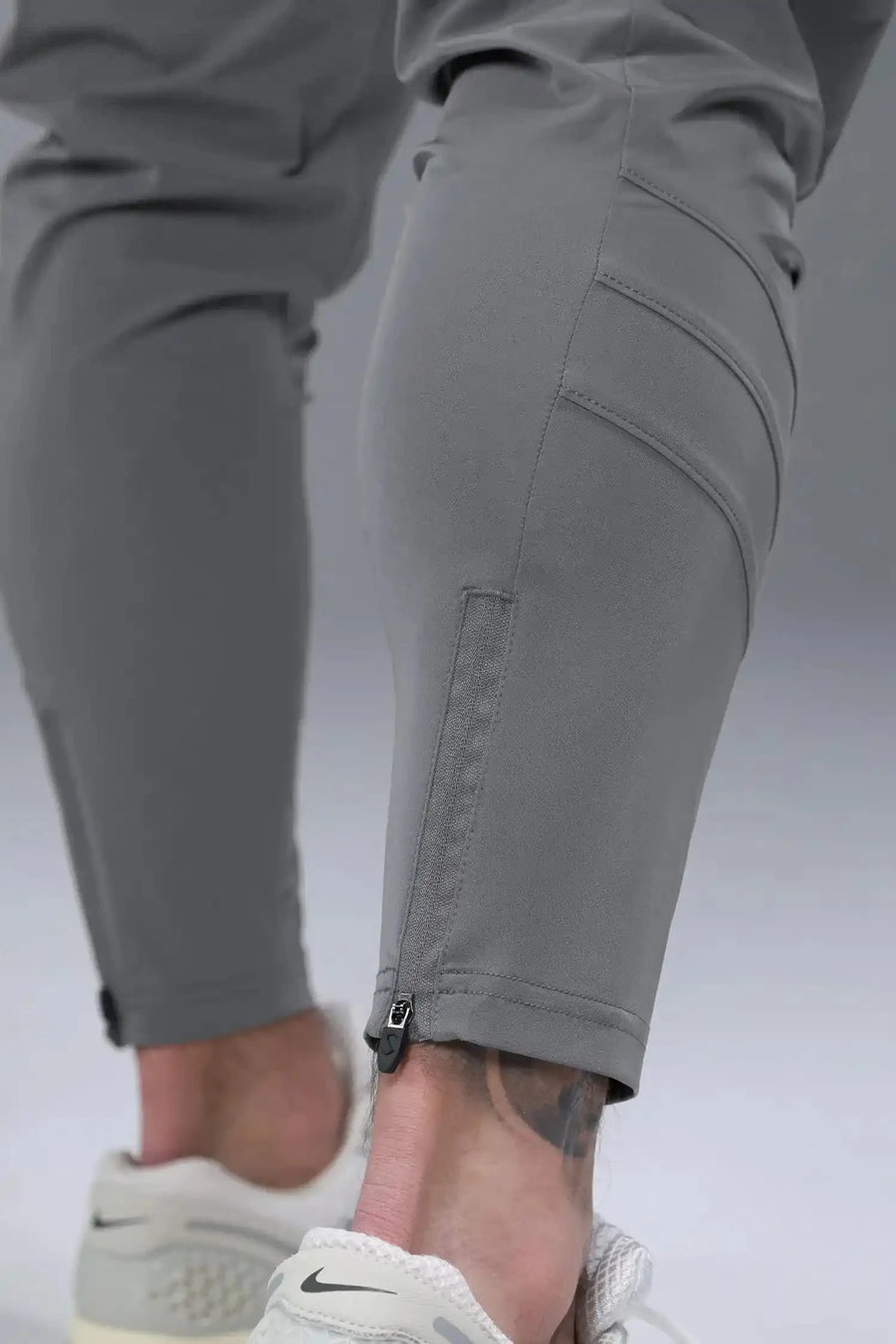 Side View of Gray TLF Train Element 7/8 Joggers 2.0, featuring side cargo pockets in an athletic 7/8 length and side zipper pockets 