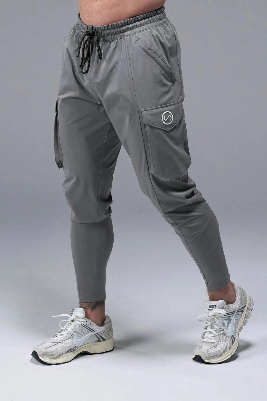 Front View of Gray TLF Train Element 7/8 Joggers 2.0, featuring side cargo pockets in an athletic 7/8 length and side zipper pockets 