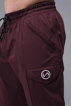 Detail Front View of Maroon TLF Train Element 7/8 Joggers 2.0, featuring side cargo pockets in an athletic 7/8 length and side zipper pockets 