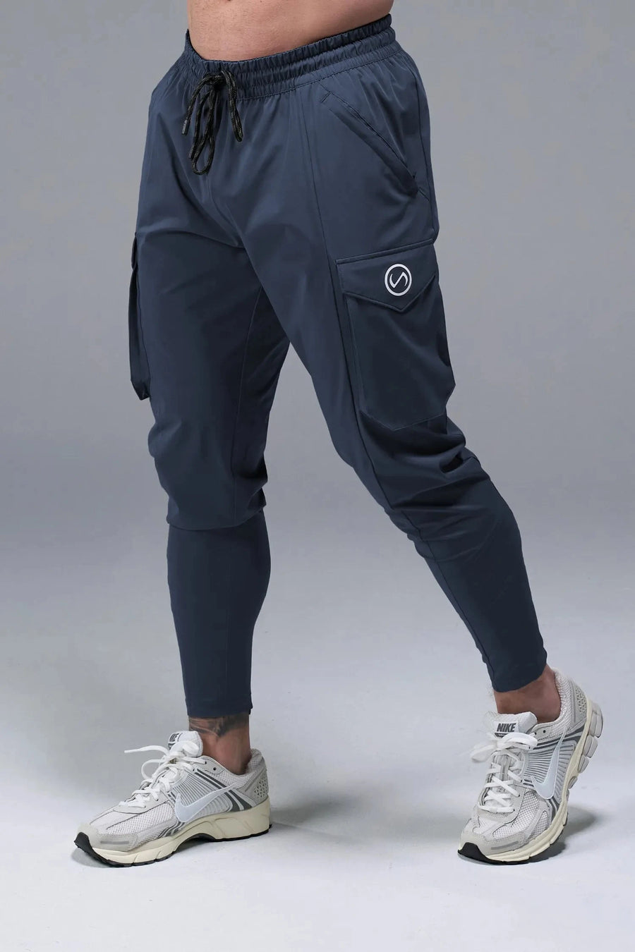 Front View of Blue TLF Train Element 7/8 Joggers 2.0, featuring side cargo pockets in an athletic 7/8 length and side zipper pockets 