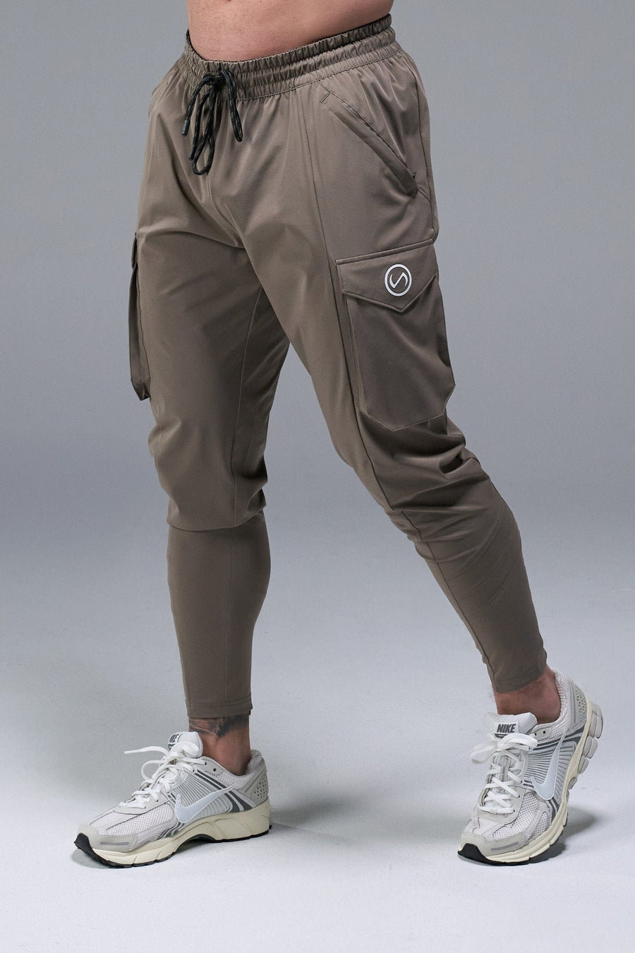 Front View of Brown TLF Train Element 7/8 Joggers 2.0, featuring side cargo pockets in an athletic 7/8 length and side zipper pockets 