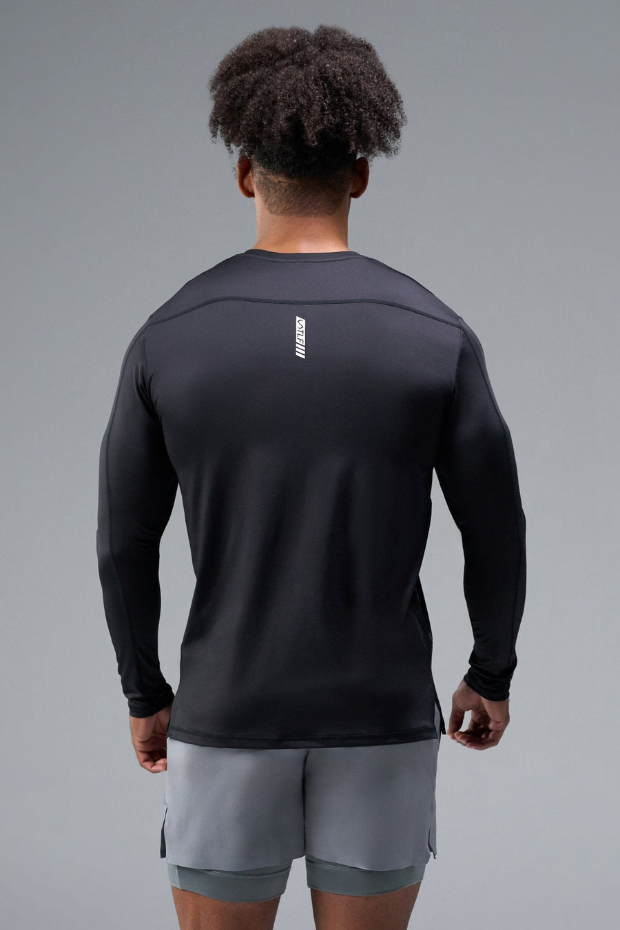 Back View of Black TLF Train Infi-Dry Long Sleeve, featuring our Infi-Dry fabric technology and reflective sleeve design for night running 