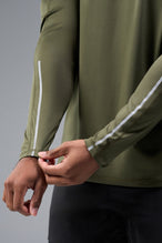 Detail View of Green TLF Train Infi-Dry Long Sleeve, featuring our Infi-Dry fabric technology and reflective sleeve design for night running 