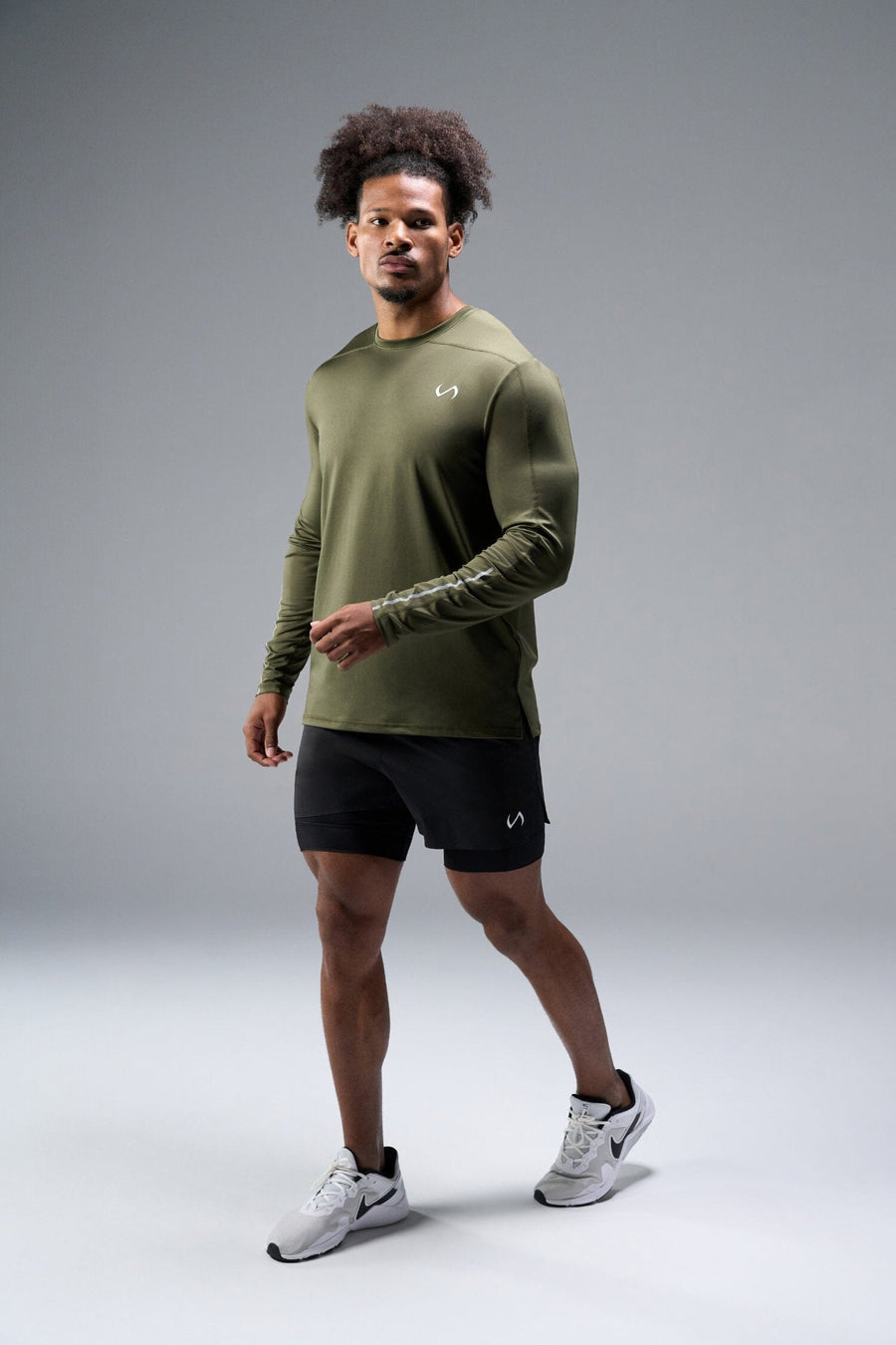 Front View of Green TLF Train Infi-Dry Long Sleeve, featuring our Infi-Dry fabric technology and reflective sleeve design for night running 