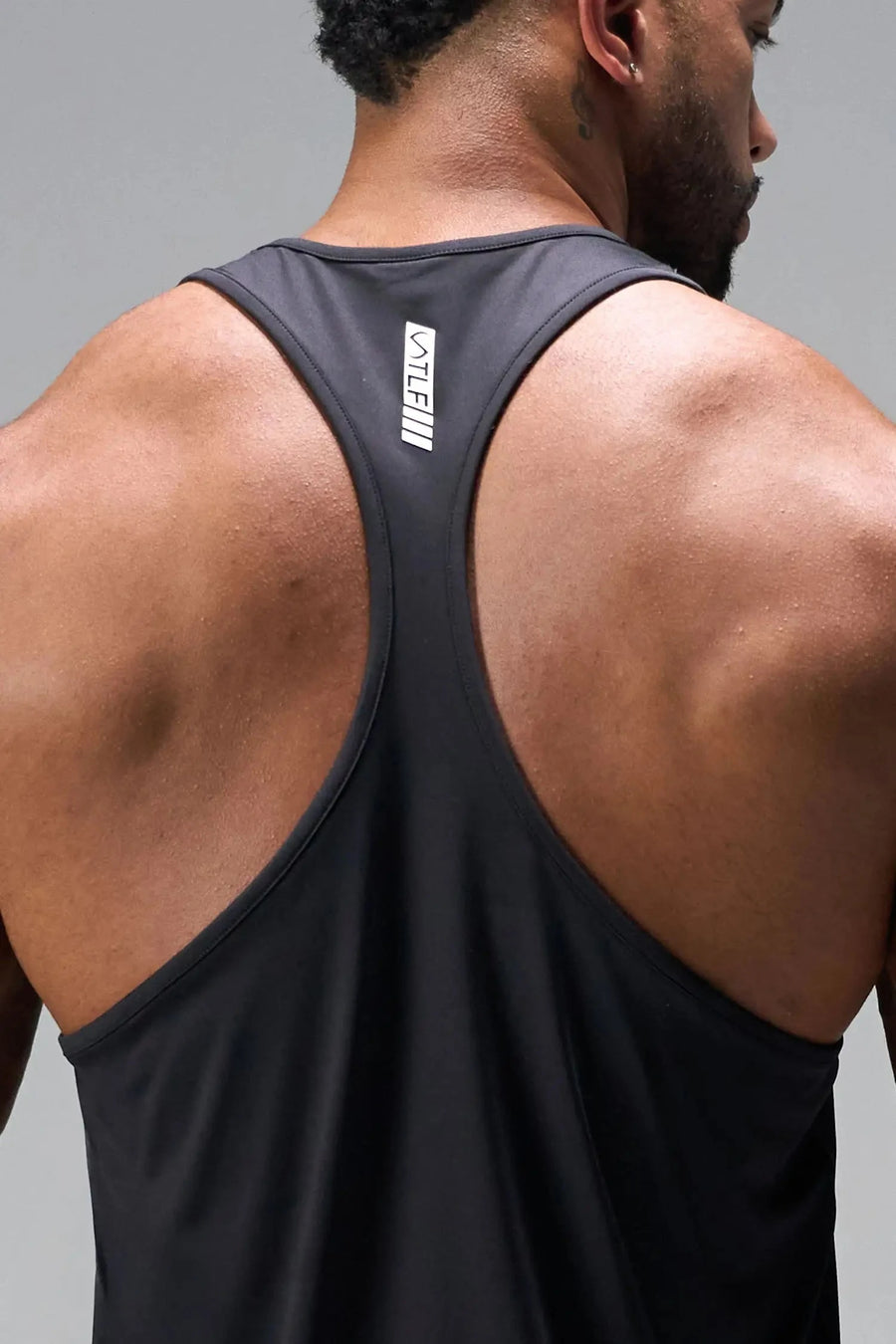Back View of Black TLF Infi Dry Stringer Tank featuring a physique enhancing design in our advanced Infi-Dry DNA fabric technology