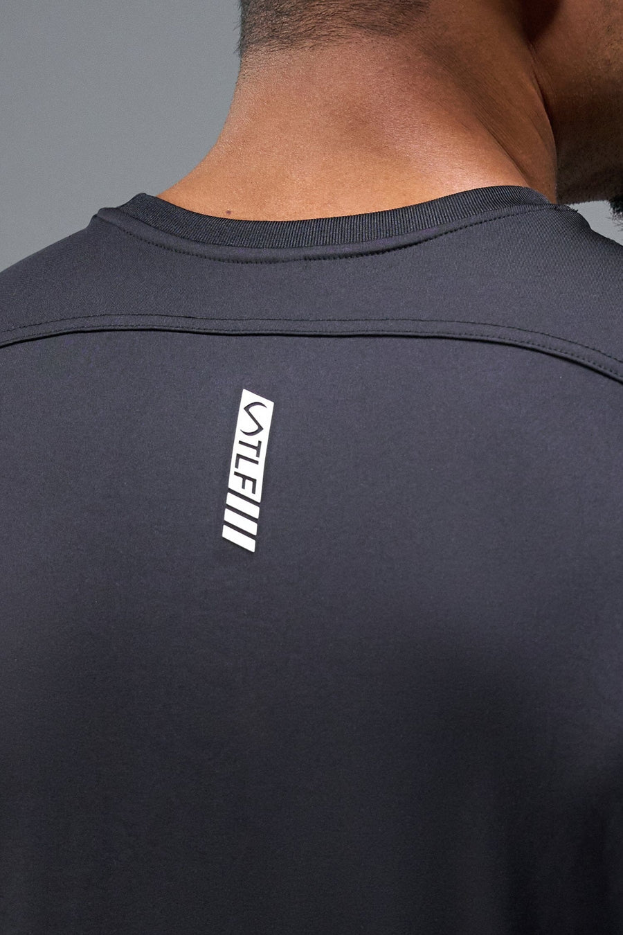 Back View of Black TLF Infi-Dry Swole Tee, crafted with our custom swole fit and utilizing our infi-dry fabric technology 